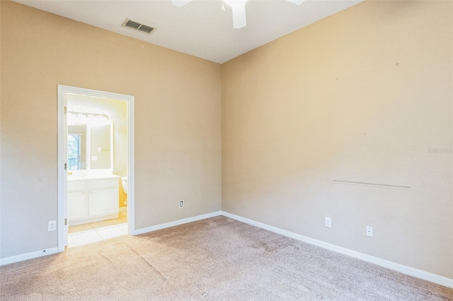 spare room with light carpet and ceiling fan