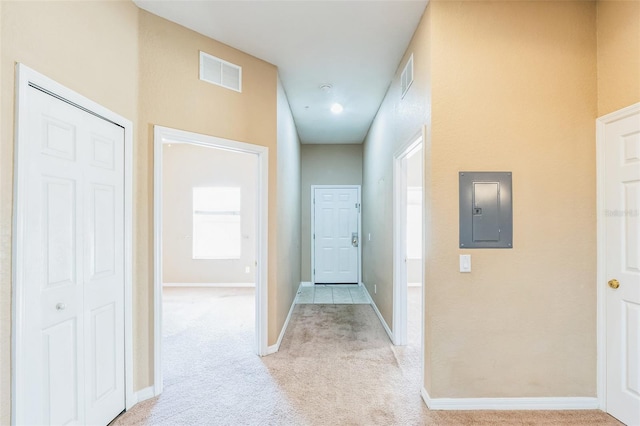 corridor featuring electric panel and light colored carpet