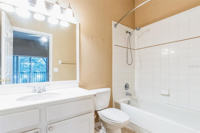 full bathroom with tiled shower / bath combo, vanity, and toilet