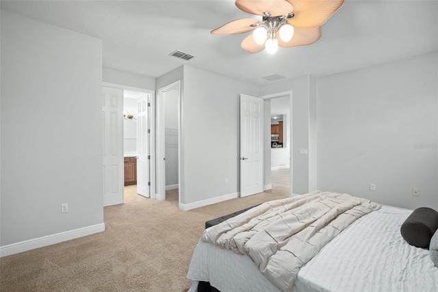 carpeted bedroom with connected bathroom and ceiling fan