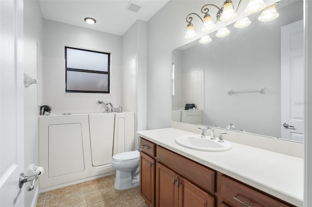 bathroom featuring vanity, toilet, and a tub