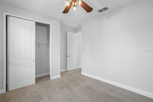 unfurnished bedroom featuring a closet, ceiling fan, and light carpet