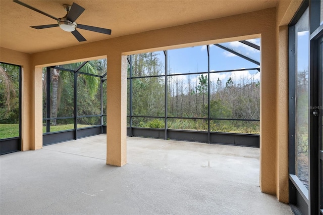 unfurnished sunroom featuring ceiling fan