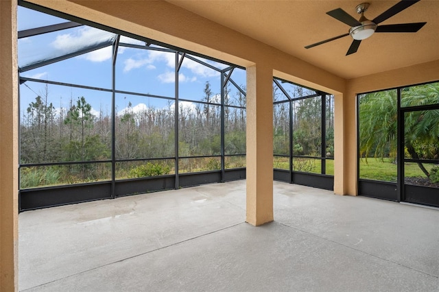 unfurnished sunroom with ceiling fan and a wealth of natural light