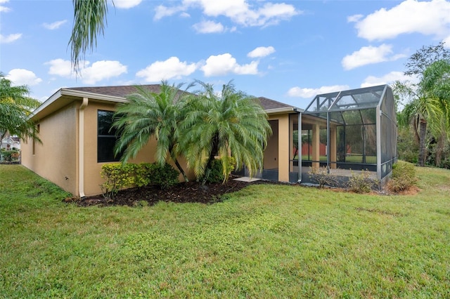 exterior space featuring a lanai and a lawn