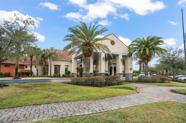 mediterranean / spanish-style house featuring a front lawn