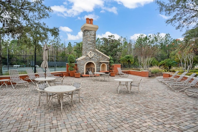 view of patio / terrace featuring an outdoor stone fireplace