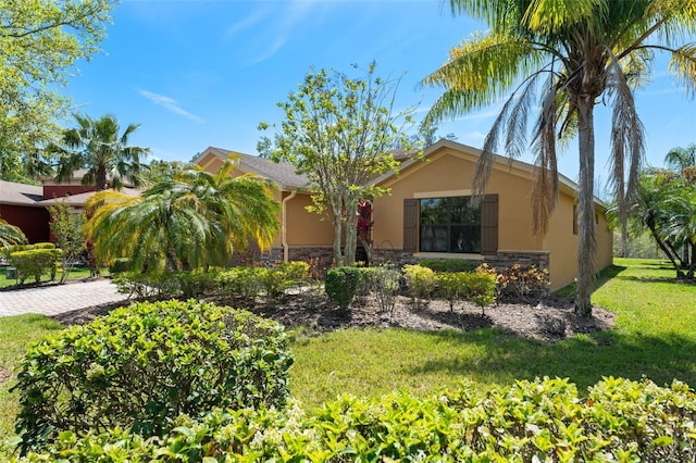 800 Ebb Tide Ln, Kissimmee, FL 34759 - view of front facade with a front lawn, stucco siding, and stone siding