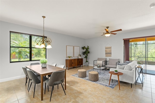 800 Ebb Tide Ln, Kissimmee, FL 34759 - dining area with baseboards, light tile patterned floors, and ceiling fan with notable chandelier