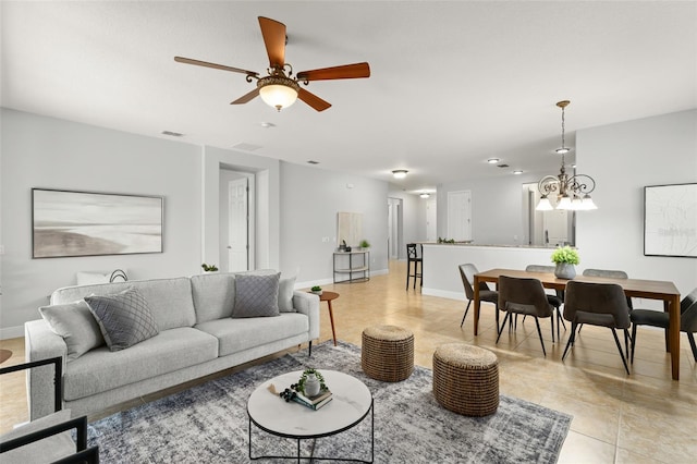 800 Ebb Tide Ln, Kissimmee, FL 34759 - living area featuring ceiling fan with notable chandelier, visible vents, baseboards, and light tile patterned floors