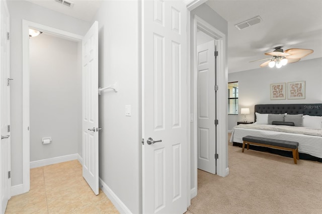 800 Ebb Tide Ln, Kissimmee, FL 34759 - bedroom featuring baseboards, visible vents, light tile patterned flooring, and light colored carpet