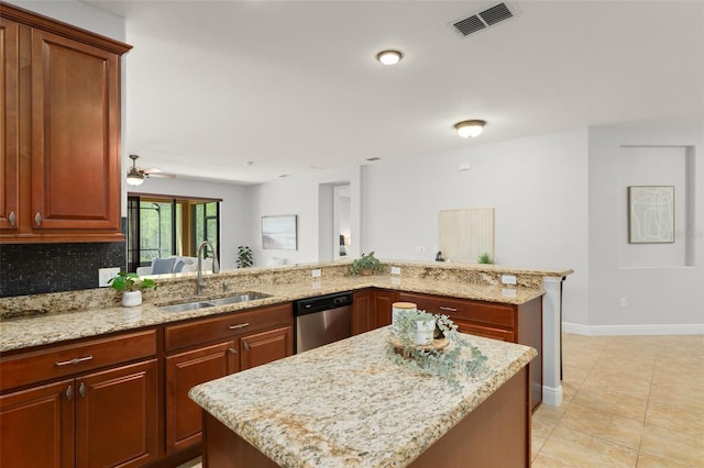 800 Ebb Tide Ln, Kissimmee, FL 34759 - kitchen with light stone counters, a sink, a kitchen island, dishwasher, and visible vents