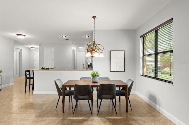 800 Ebb Tide Ln, Kissimmee, FL 34759 - dining area with baseboards, light tile patterned floors, and an inviting chandelier