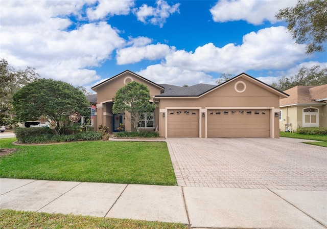 view of front of home with a front lawn and a garage