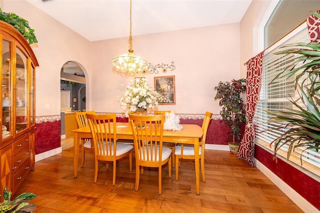 dining area with an inviting chandelier and hardwood / wood-style flooring