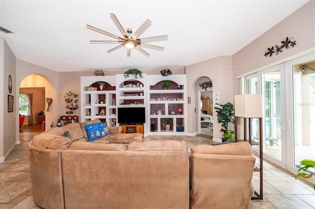 living room featuring ceiling fan and french doors