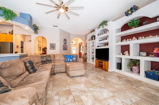 living room with ceiling fan and built in shelves