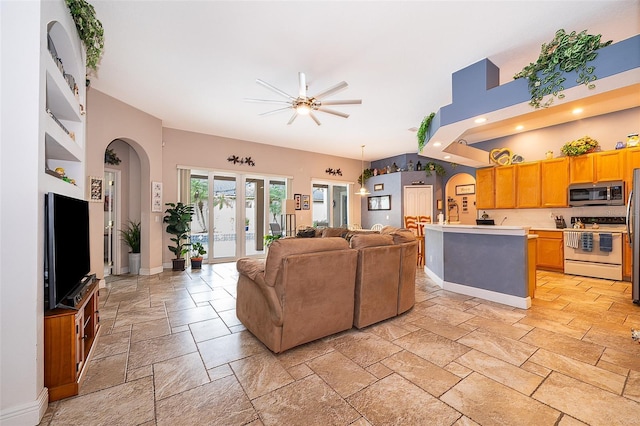 living room featuring ceiling fan and french doors