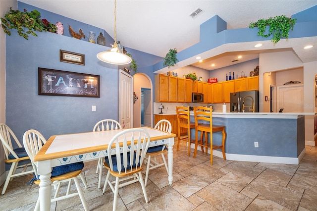 dining area with a high ceiling