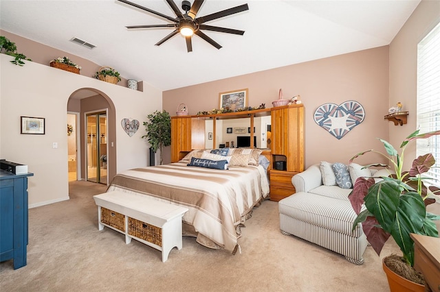 carpeted bedroom featuring ceiling fan, connected bathroom, and lofted ceiling