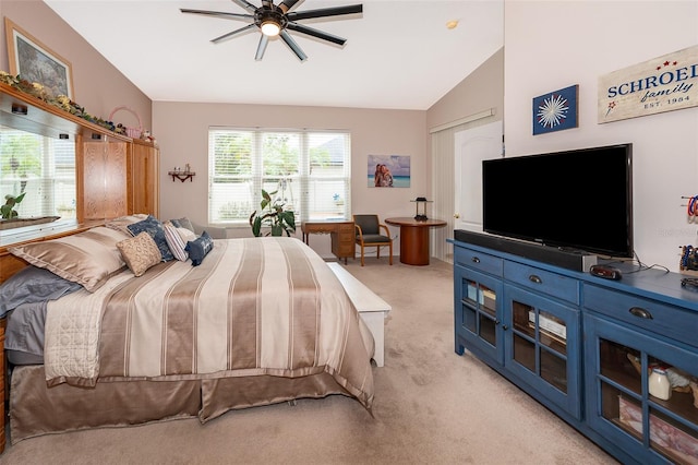 bedroom with ceiling fan, light colored carpet, and vaulted ceiling