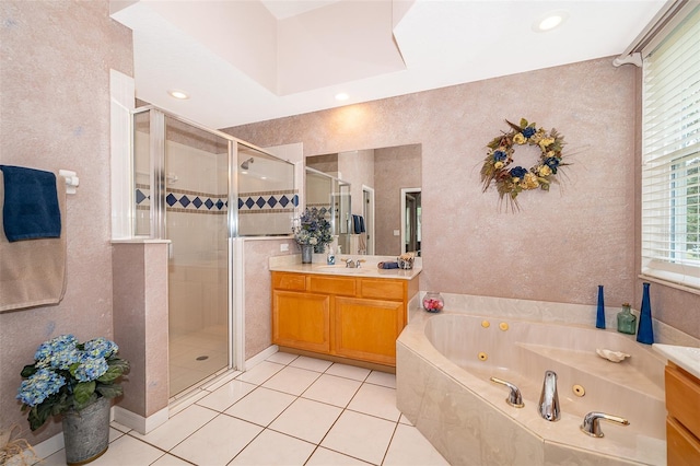 bathroom featuring independent shower and bath, tile patterned floors, and vanity