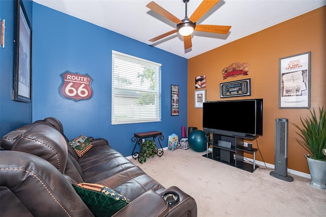 carpeted living room with ceiling fan