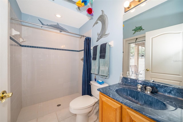 bathroom with toilet, tile patterned flooring, vanity, and curtained shower