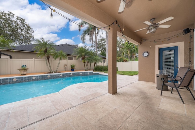 view of swimming pool featuring ceiling fan and a patio