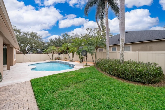 view of swimming pool with a lawn and a patio