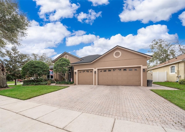 view of front of house featuring a garage and a front lawn