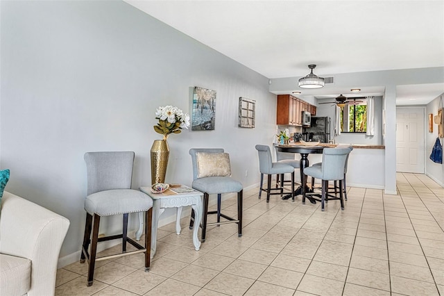 tiled dining area featuring ceiling fan