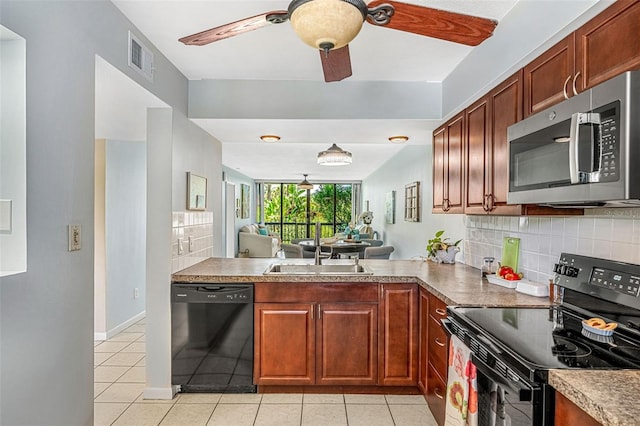 kitchen featuring light tile patterned floors, decorative backsplash, sink, and black appliances