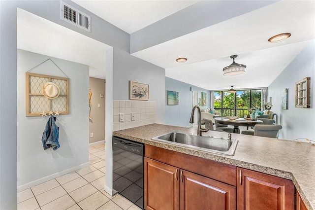 kitchen with light tile patterned floors, backsplash, sink, and black dishwasher