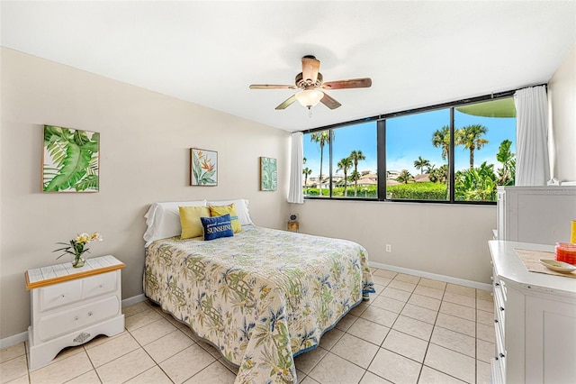 tiled bedroom featuring ceiling fan