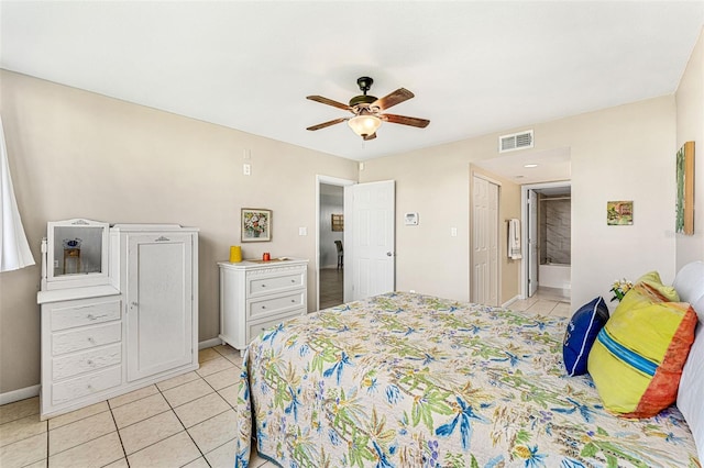 tiled bedroom featuring ceiling fan and ensuite bathroom