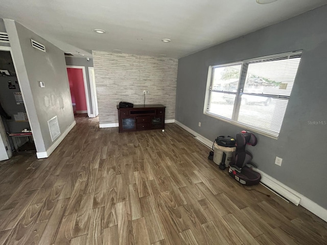 unfurnished living room with dark hardwood / wood-style flooring