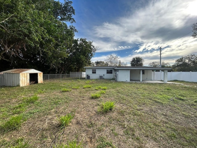 view of yard featuring a storage shed and a patio