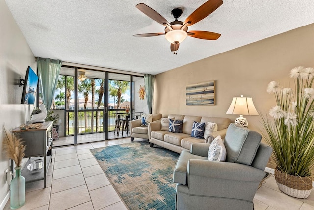 living room featuring light tile patterned flooring, floor to ceiling windows, and a textured ceiling