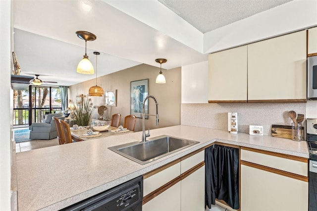 kitchen with pendant lighting, sink, ceiling fan, black dishwasher, and kitchen peninsula