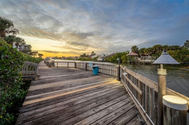 view of dock with a gazebo and a water view