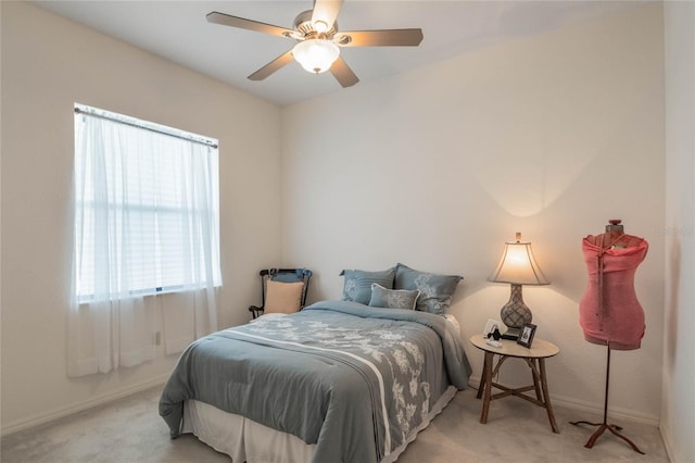 bedroom with ceiling fan and light carpet