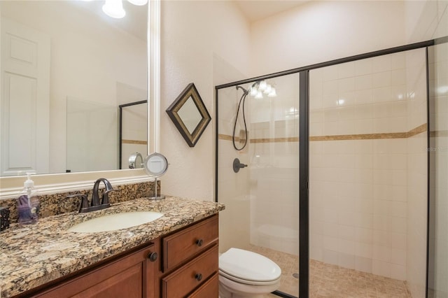 bathroom with toilet, walk in shower, and vanity