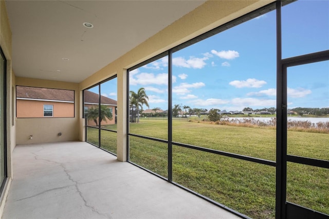 unfurnished sunroom with a water view