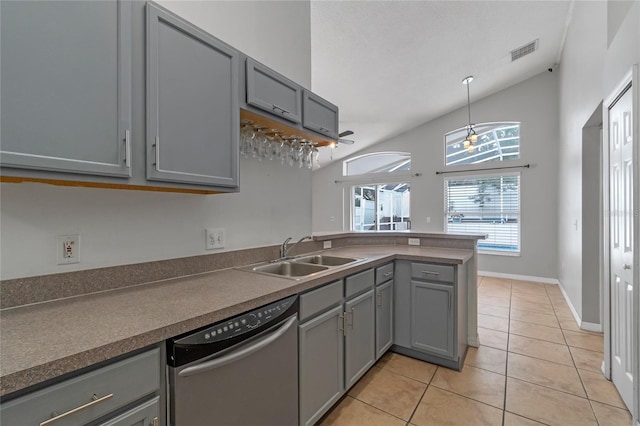 kitchen with sink, stainless steel dishwasher, gray cabinets, and lofted ceiling