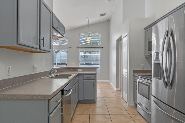 kitchen with sink, hanging light fixtures, gray cabinetry, stainless steel appliances, and light tile patterned floors