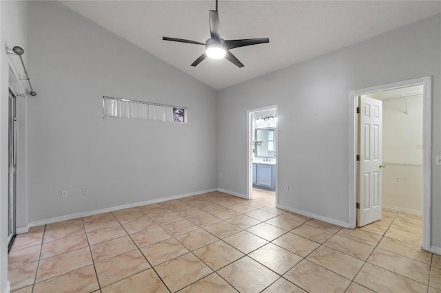 tiled empty room with lofted ceiling and ceiling fan