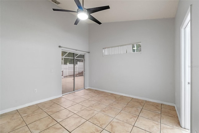 unfurnished bedroom featuring ceiling fan, light tile patterned flooring, a closet, and vaulted ceiling