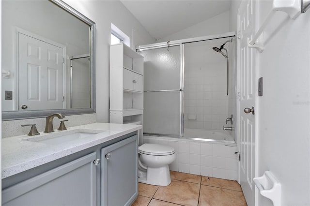 full bathroom with toilet, combined bath / shower with glass door, tile patterned flooring, lofted ceiling, and vanity