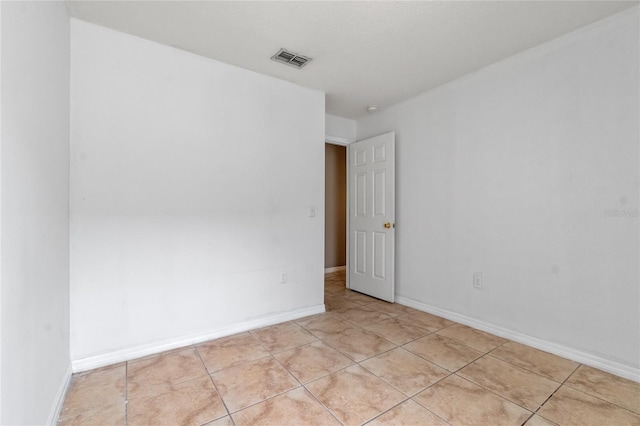 unfurnished room featuring light tile patterned floors